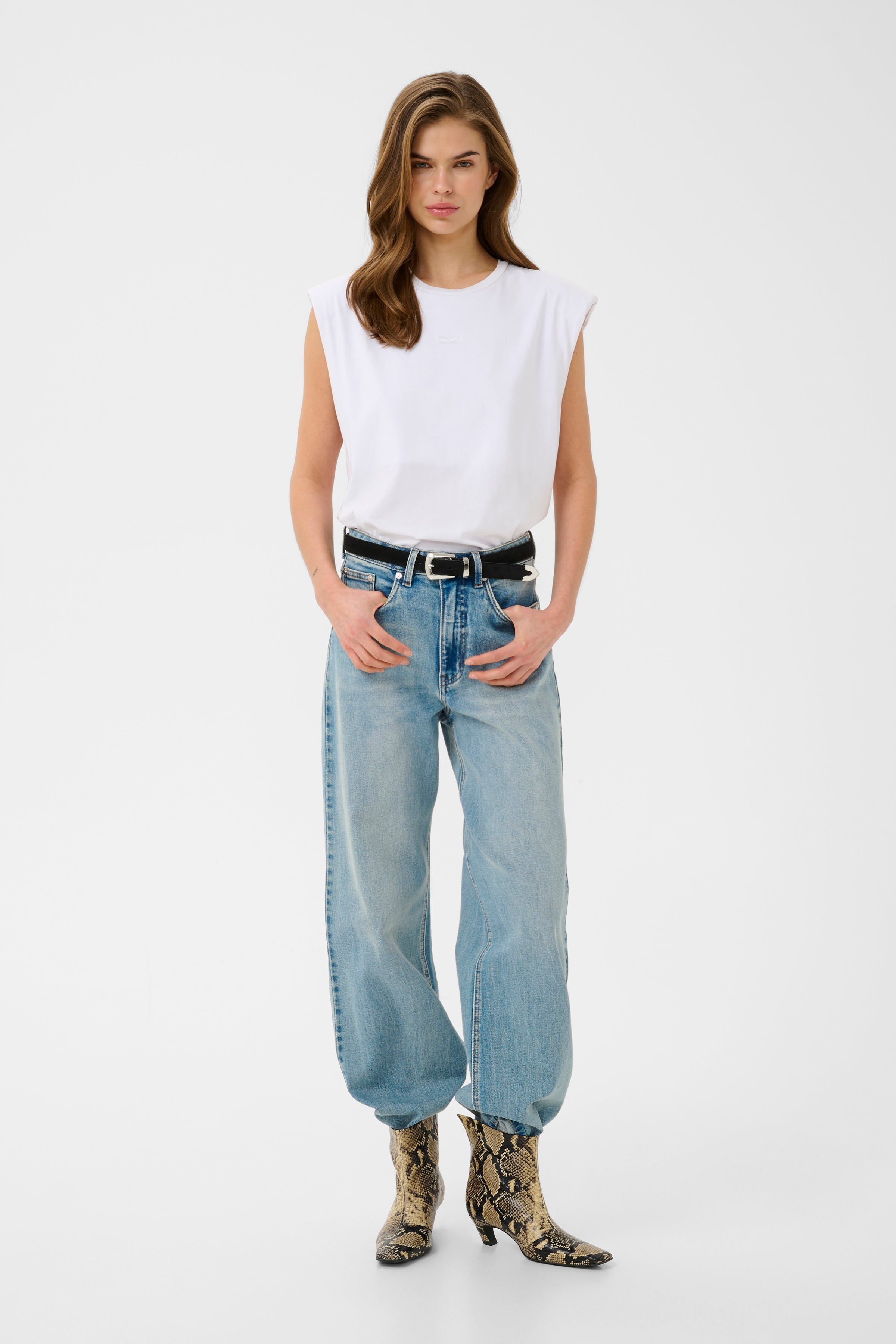 Woman wearing snakeskin ankle boots with jeans
